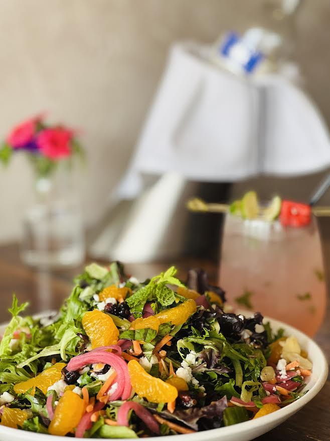 Fresh mixed greens with citrus, goat cheese, and seasonal garnish